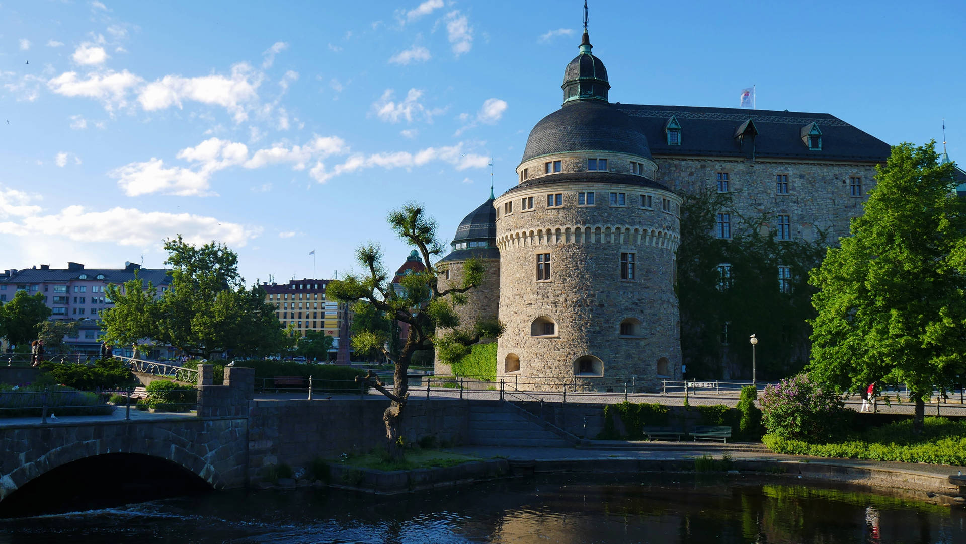 Magnificently Built Castle With A Beautiful Moat And Stone Bridge. Background