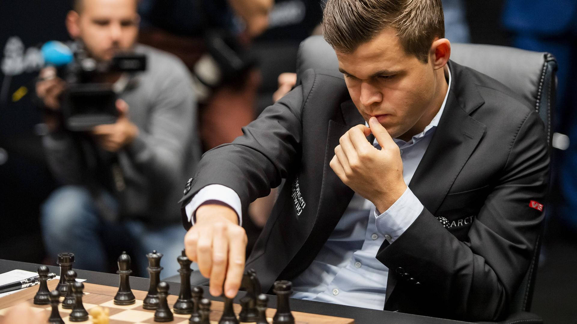 Magnus Carlsen Black Chess Pieces Background