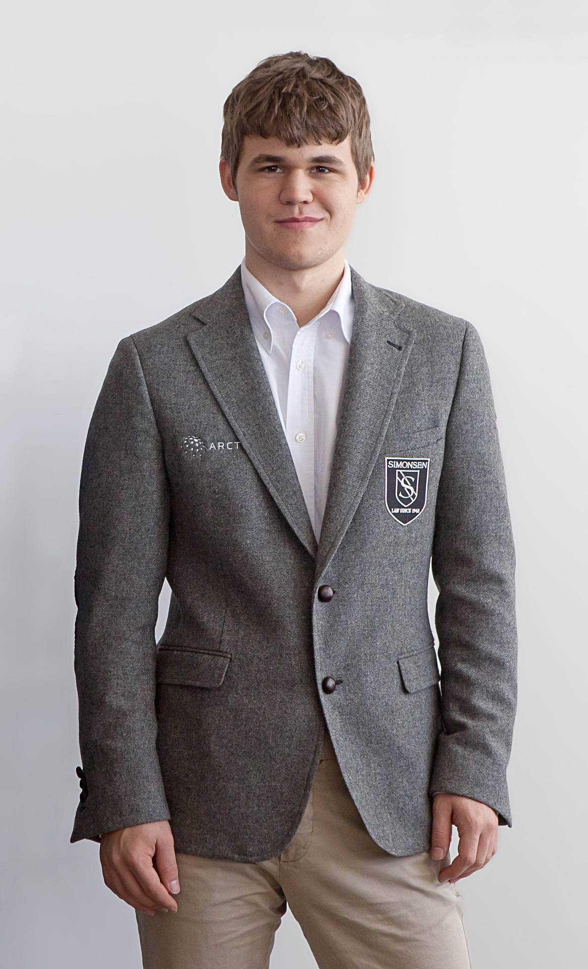 Magnus Carlsen In Cashmere Overcoat Background