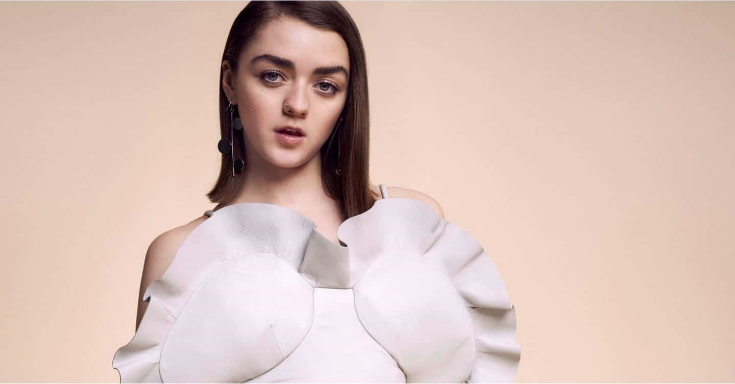 Maisie Williams Glowing In A Sunset Hue Background