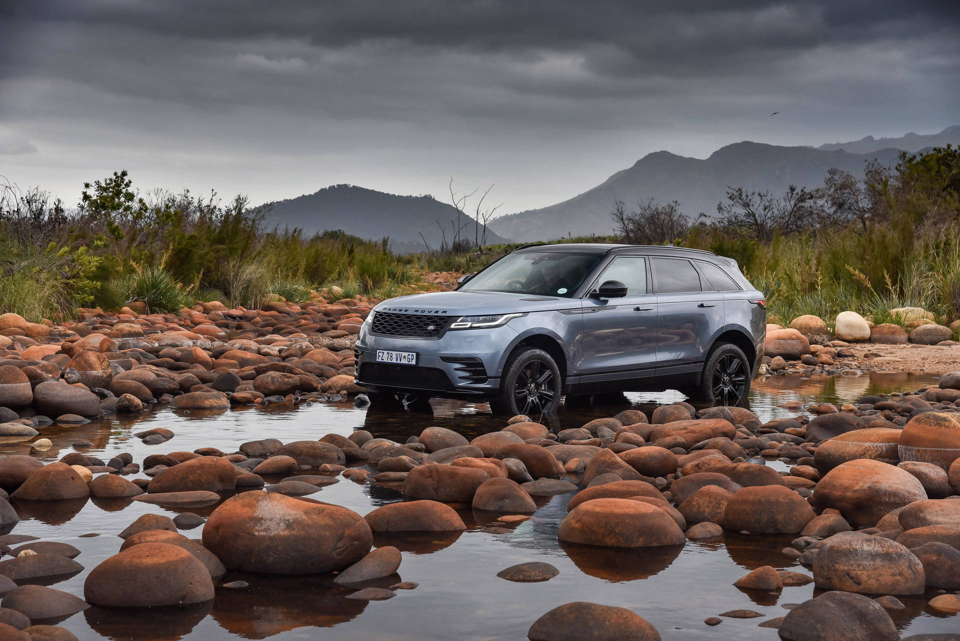 Majestic 4k Range Rover Velar Amidst Nature's Stones Background