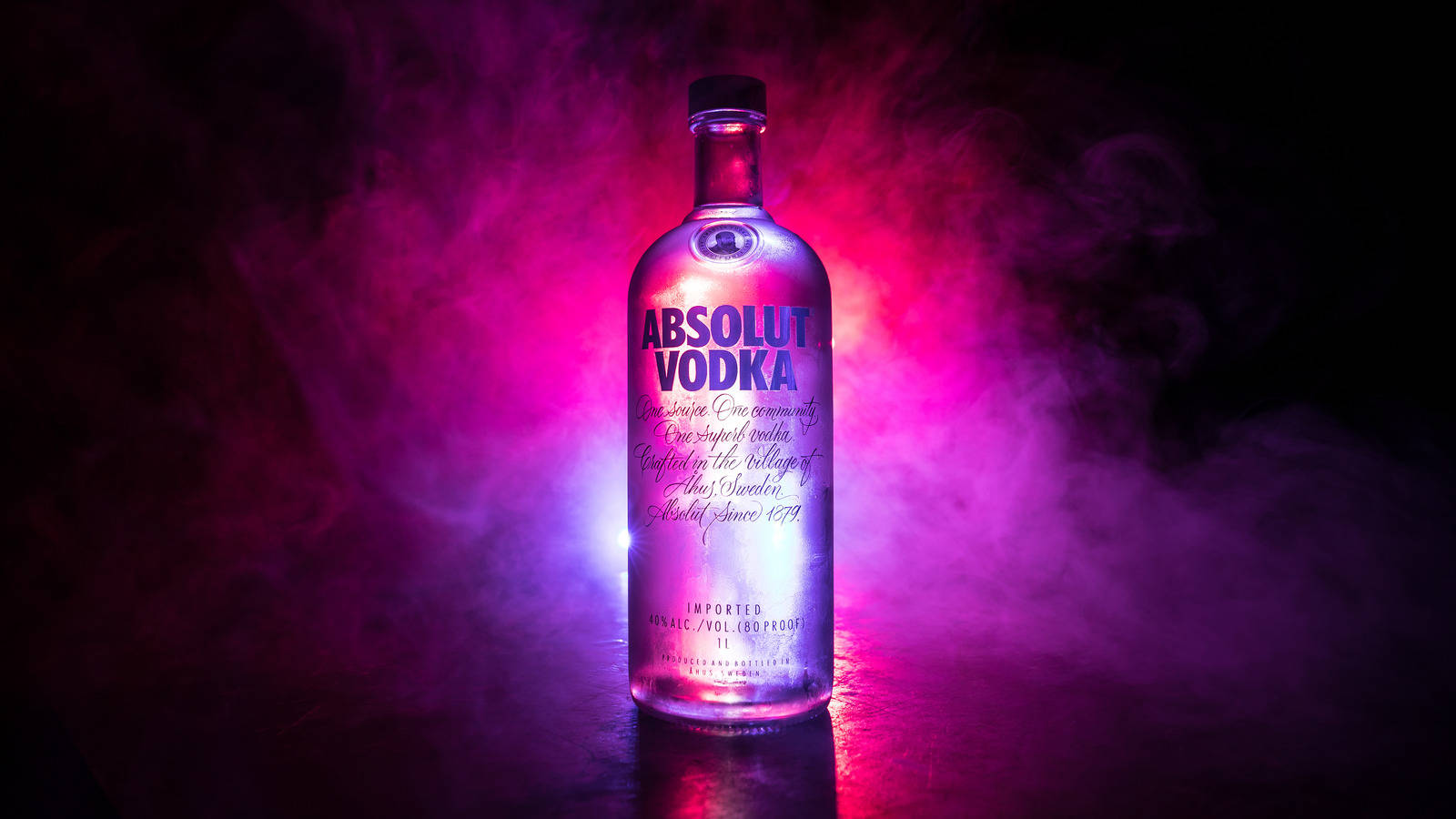 Majestic Absolut Vodka Bottle Amidst Purple Smoke Background