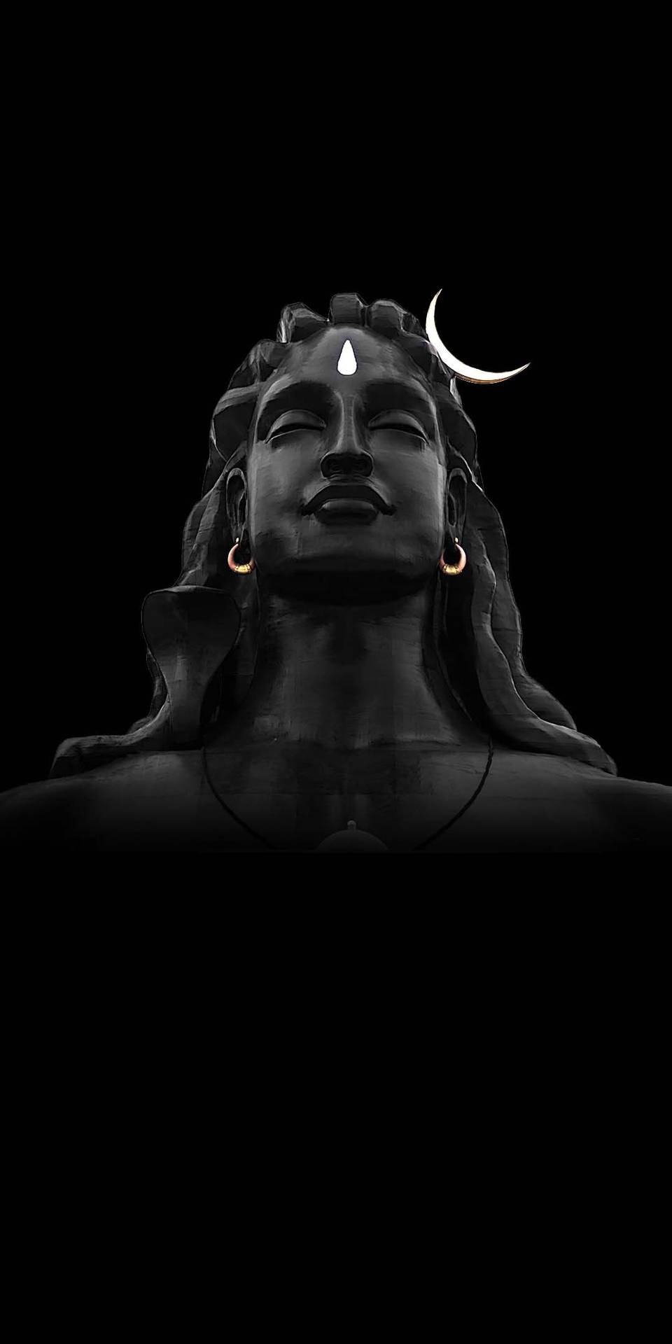 Majestic Adiyogi Shiva Statue Against A Dark Night Sky Background