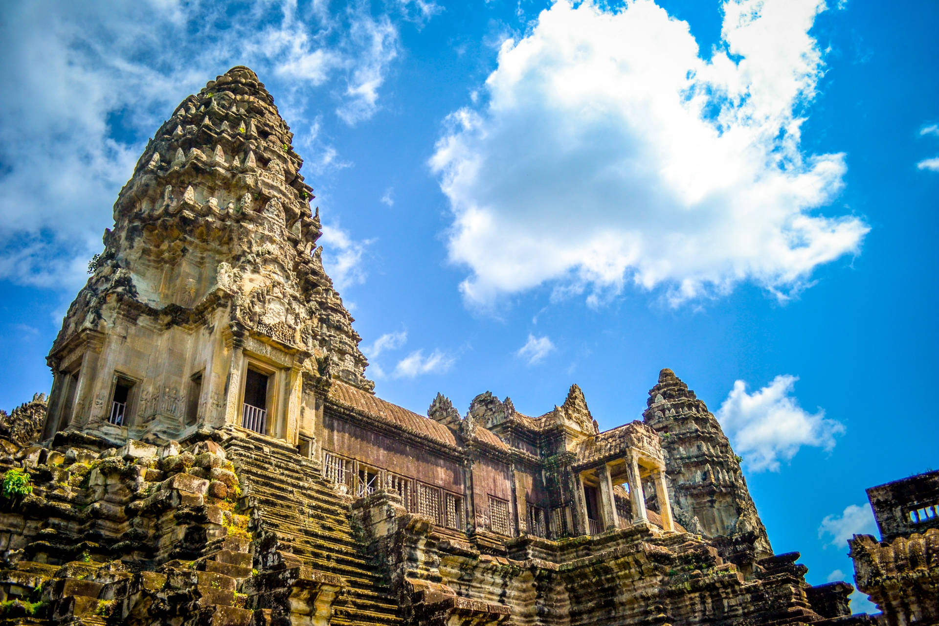 Majestic Angkor Wat Under A Brilliant Blue Sky Background