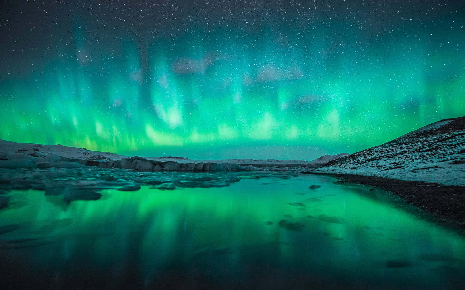 Majestic Aurora Borealis Over Snowy Mountains