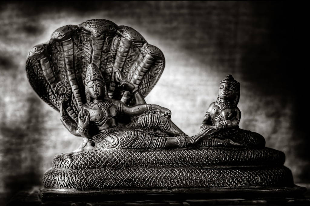 Majestic Black Figurine Of Lord Vishnu Background
