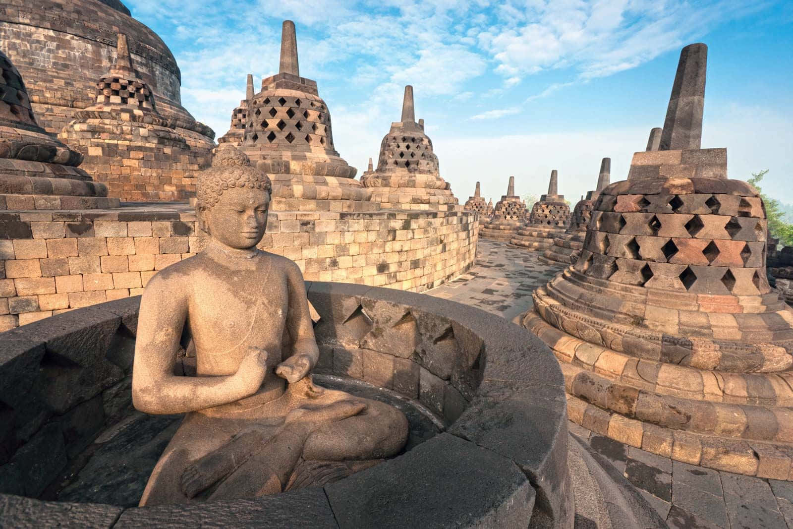Majestic Borobudur Temple Against Vibrant Blue Sky Background