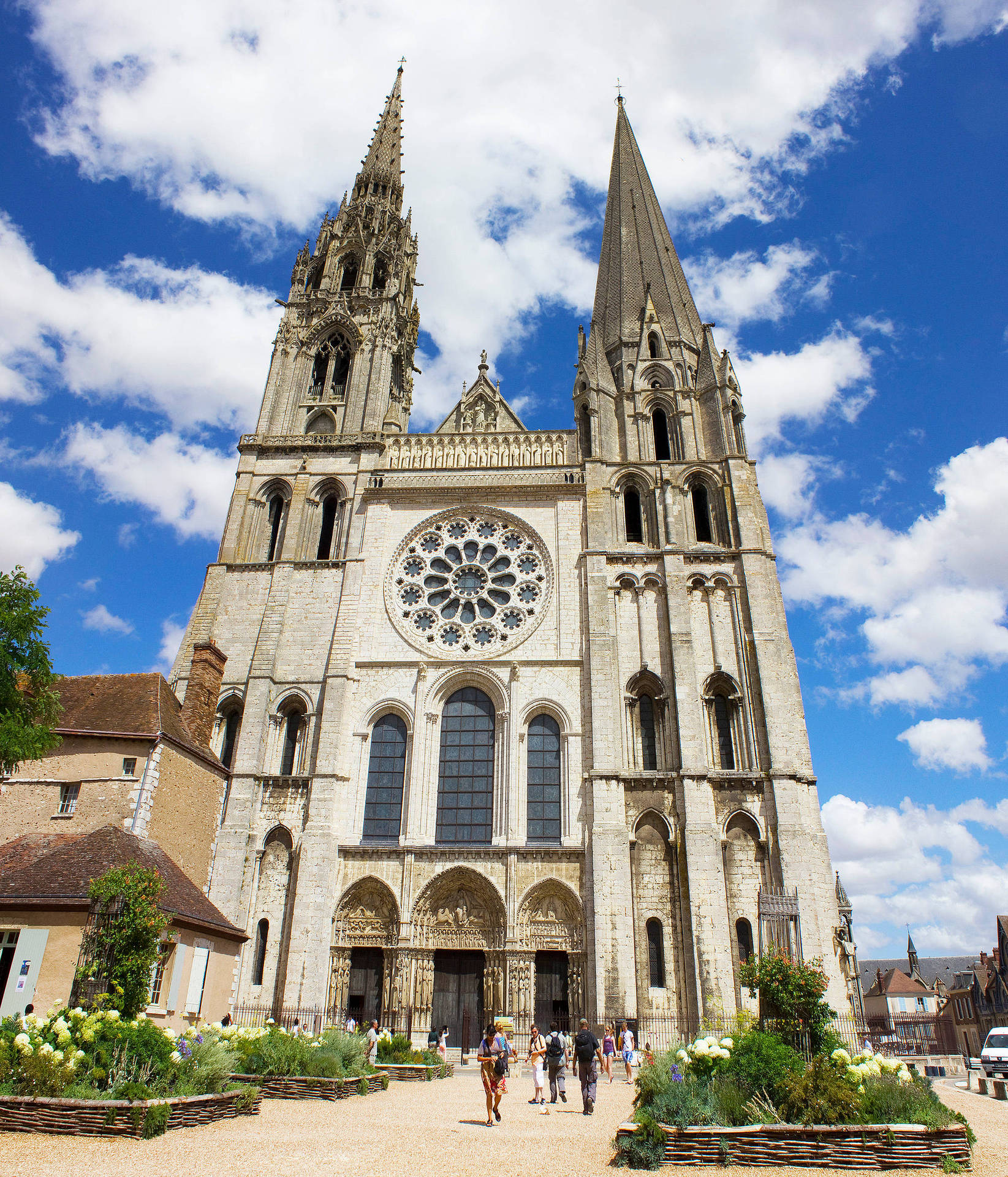 Majestic Chartres Cathedral Under The Parisian Sky Background