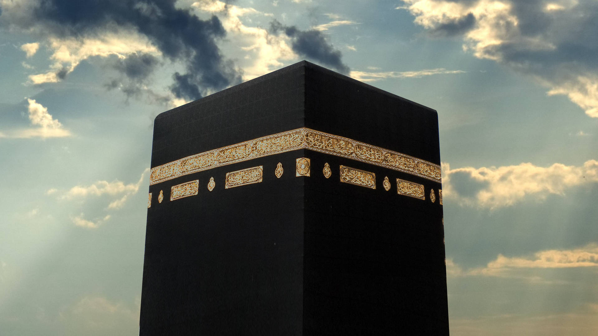 Majestic Close-up View Of Kaaba Under Dark Clouds Background