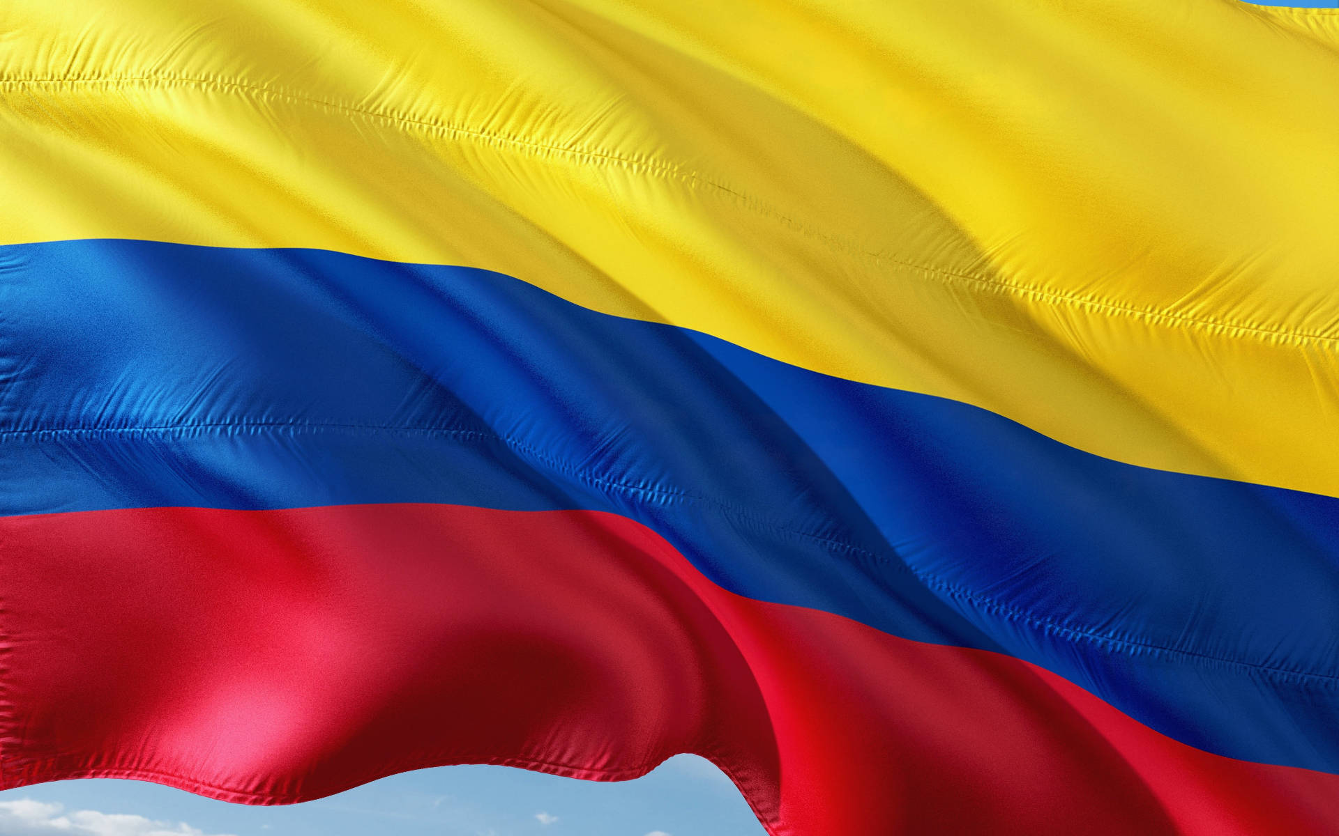 Majestic Colombian Flag Waving Under The Open Sky