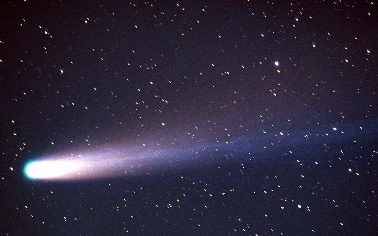 Majestic Comet Illuminating The Night Sky Background