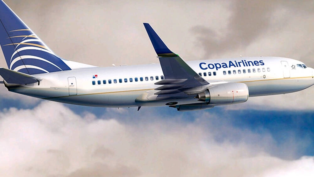 Majestic Copa Airlines Plane Soaring Through The Cloudy Sky Background