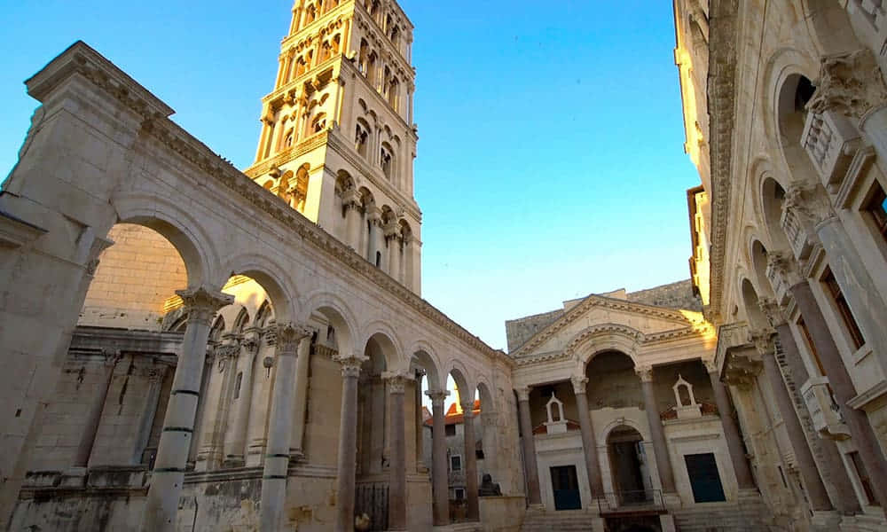 Majestic Diocletian's Palace Against A Vibrant Blue Sky Background