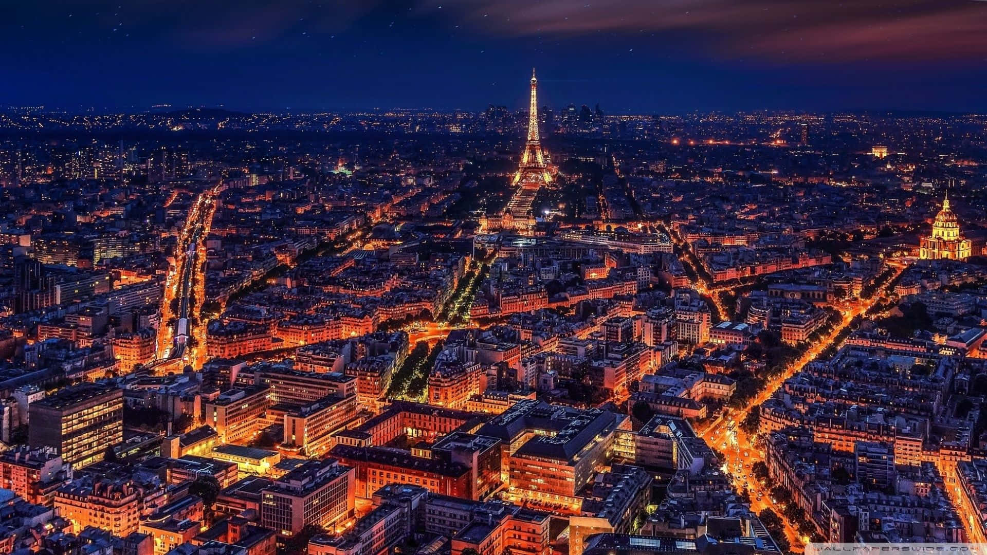 Majestic Eiffel Tower Illuminated At Night In Paris Background