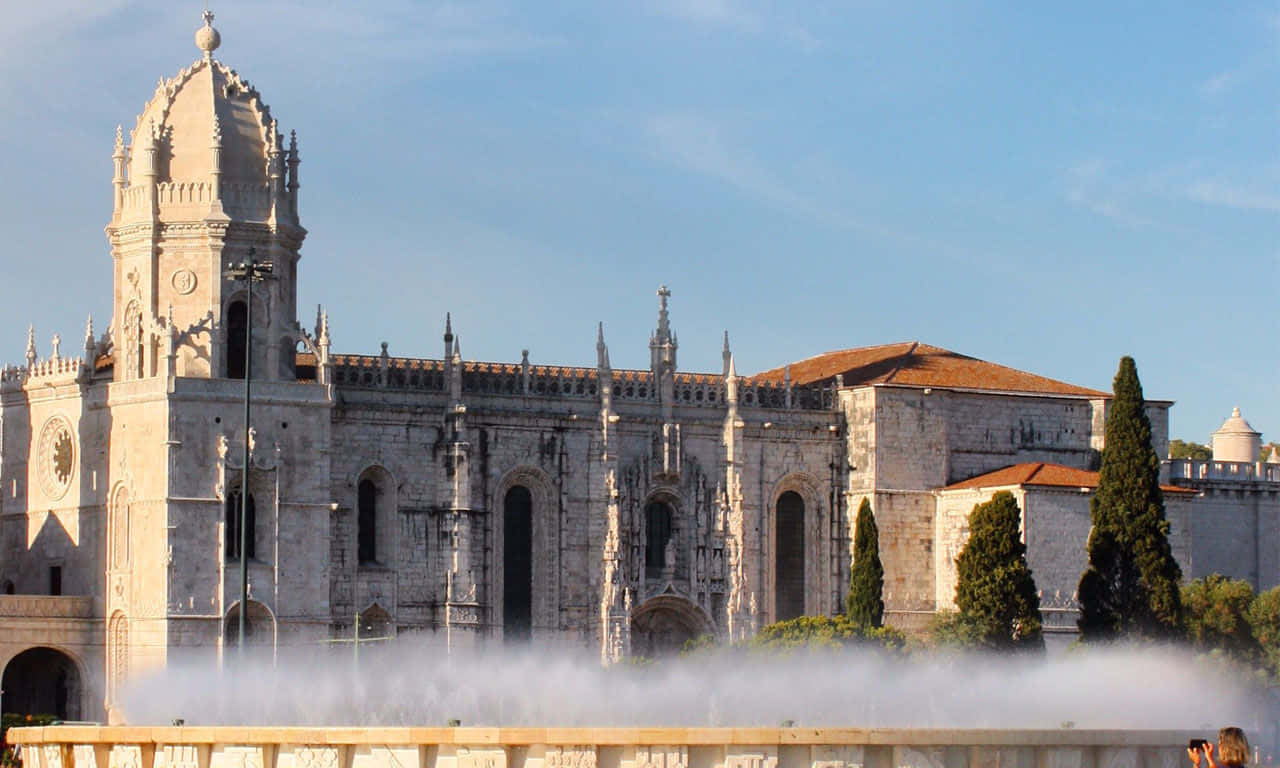Majestic Fountain In Front Of Mosteiro Dos Jeronimos, Lisbon Background