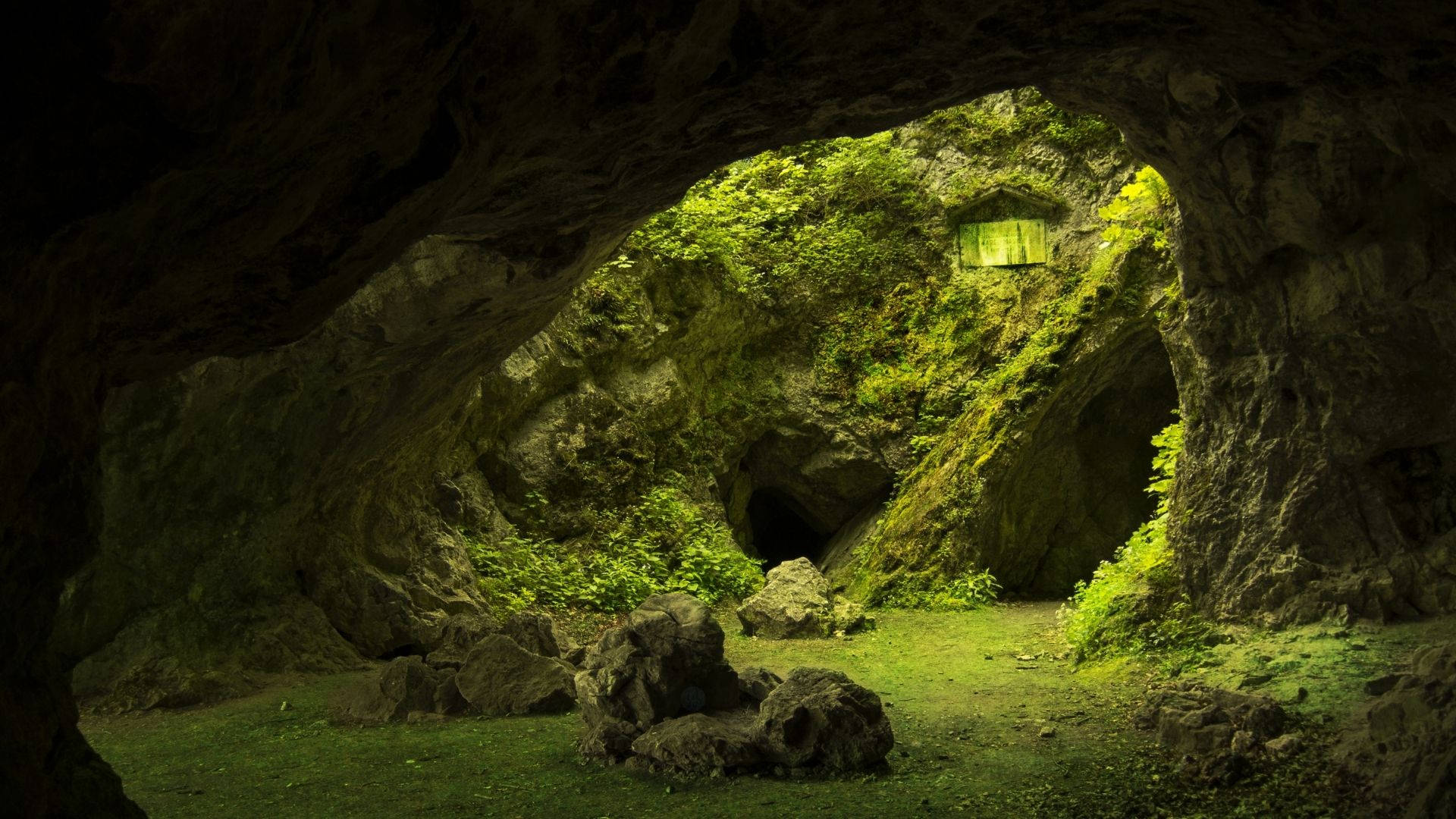 Majestic Green Cave Showcasing Nature's Artistry Background