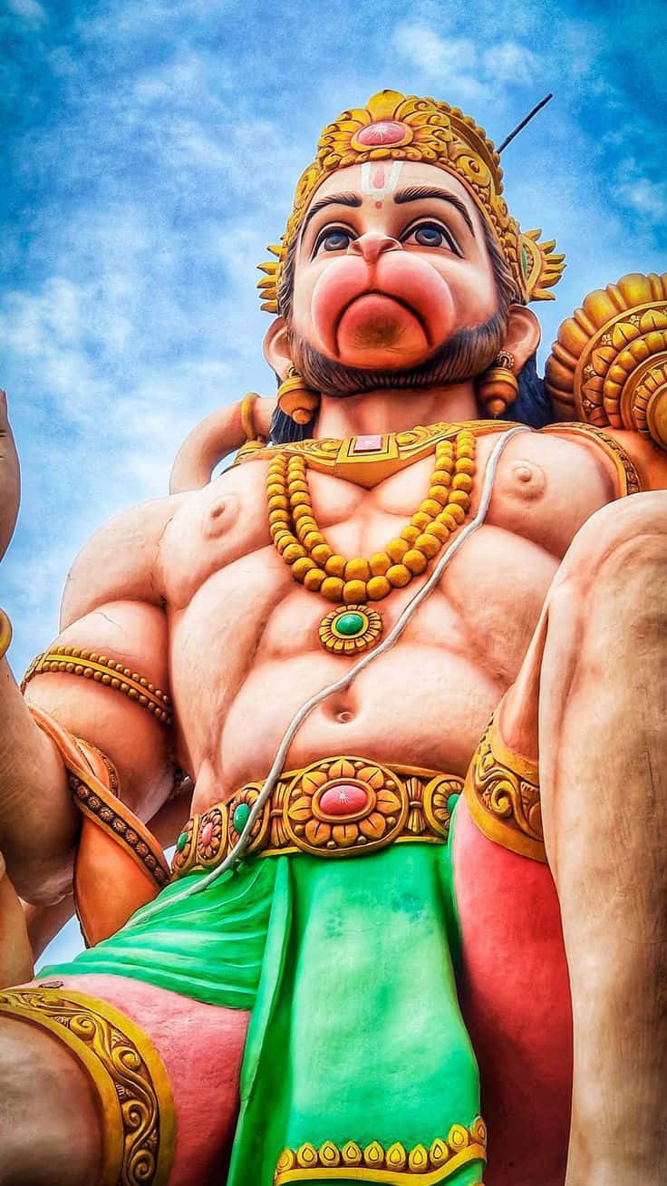 Majestic Hanuman Statue Sky Backdrop Background