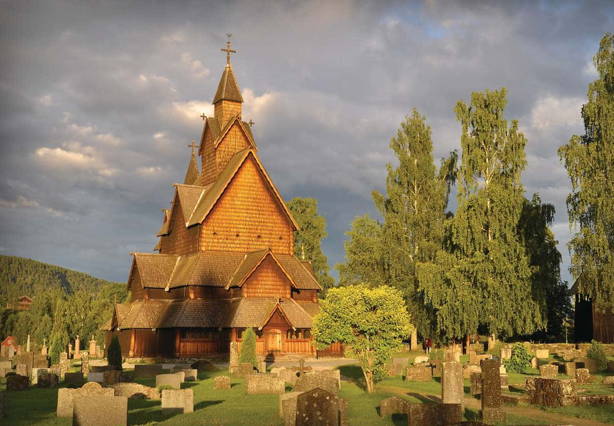 Majestic Heddal Stave Church Against The Backdrop Of A Golden Sky