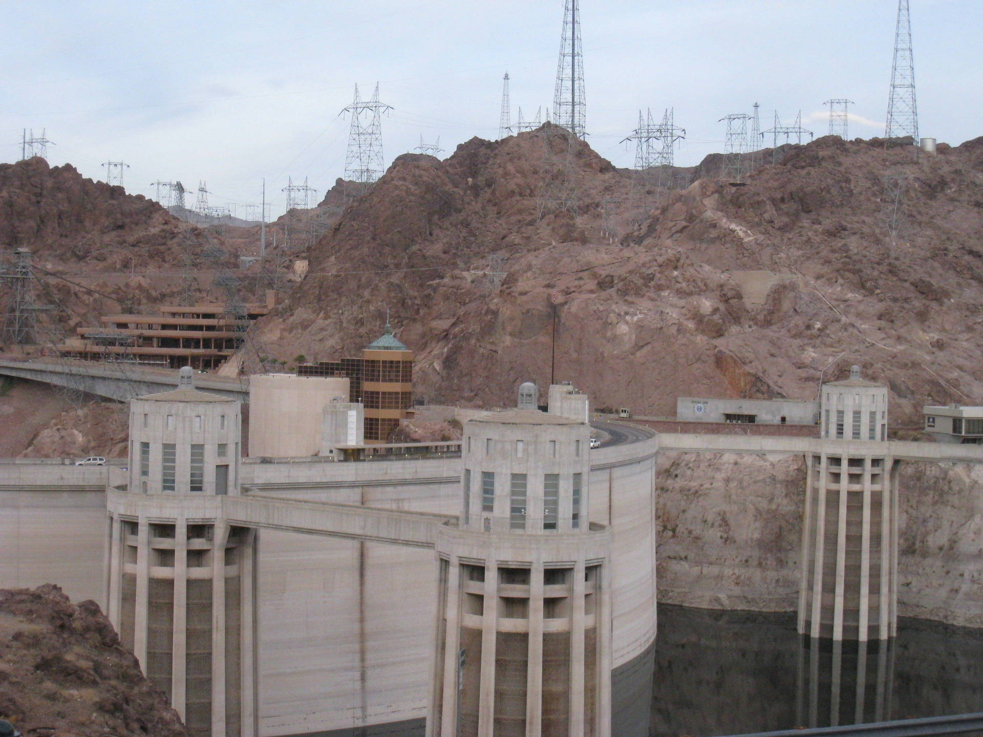 Majestic Hoover Dam Captured In Mid-day Brilliance Background