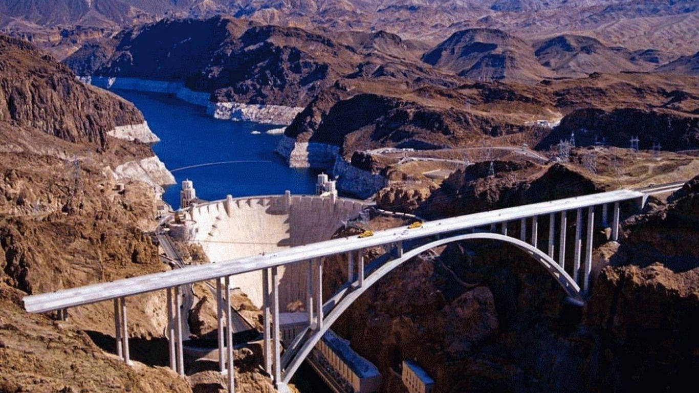 Majestic Hoover Dam Infrastructure With Bridge Construction Background