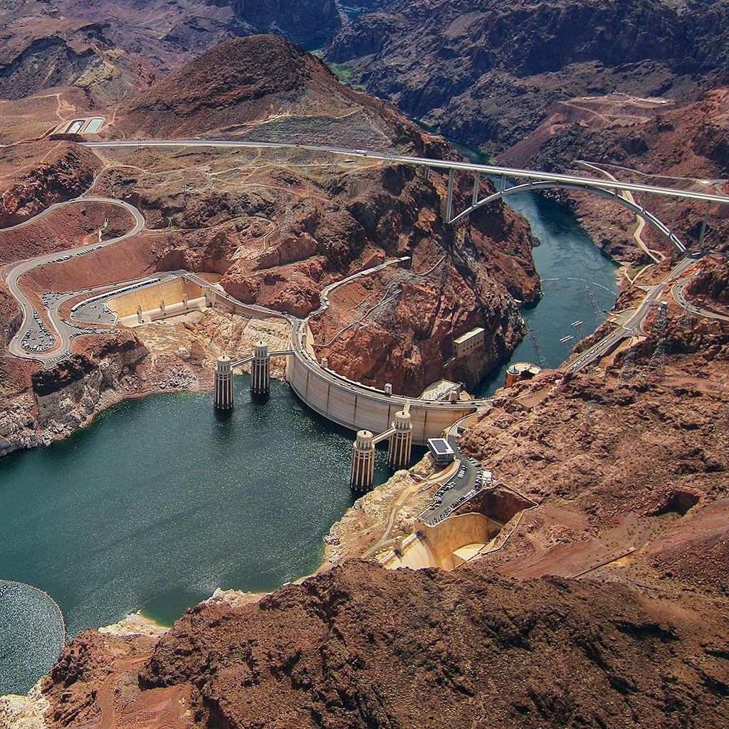 Majestic Hoover Dam Nestled In A Rocky Landscape