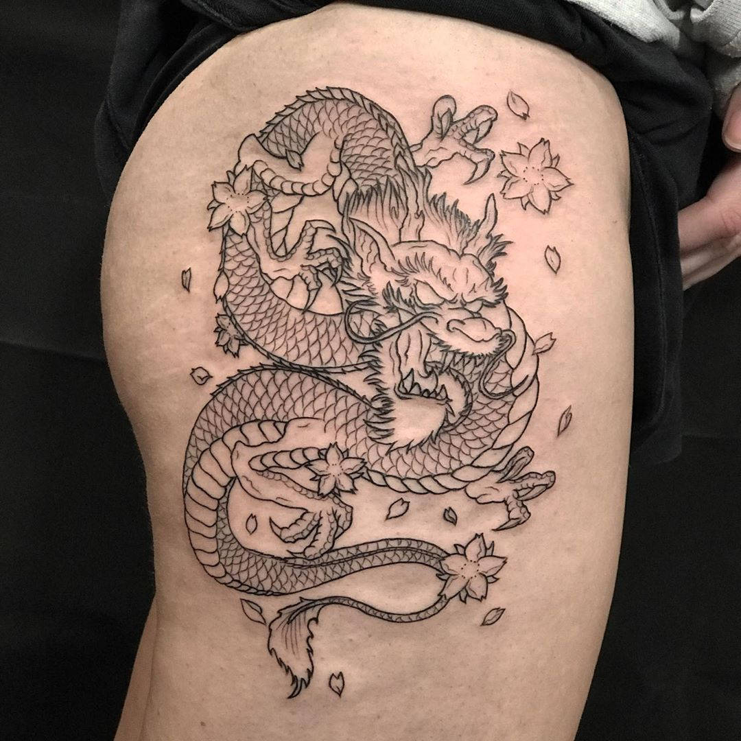 Majestic Japanese Dragon Tattoo Etched On Thigh Background