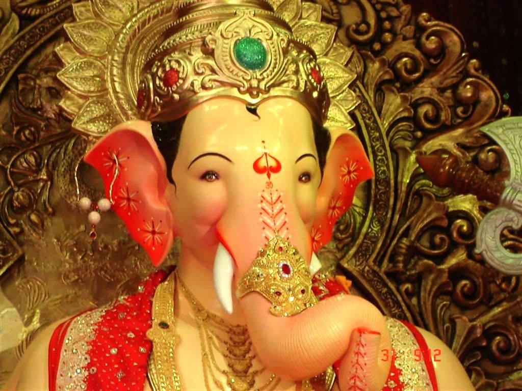 Majestic Lalbaugcha Raja Adorned With Crown And Gems Background