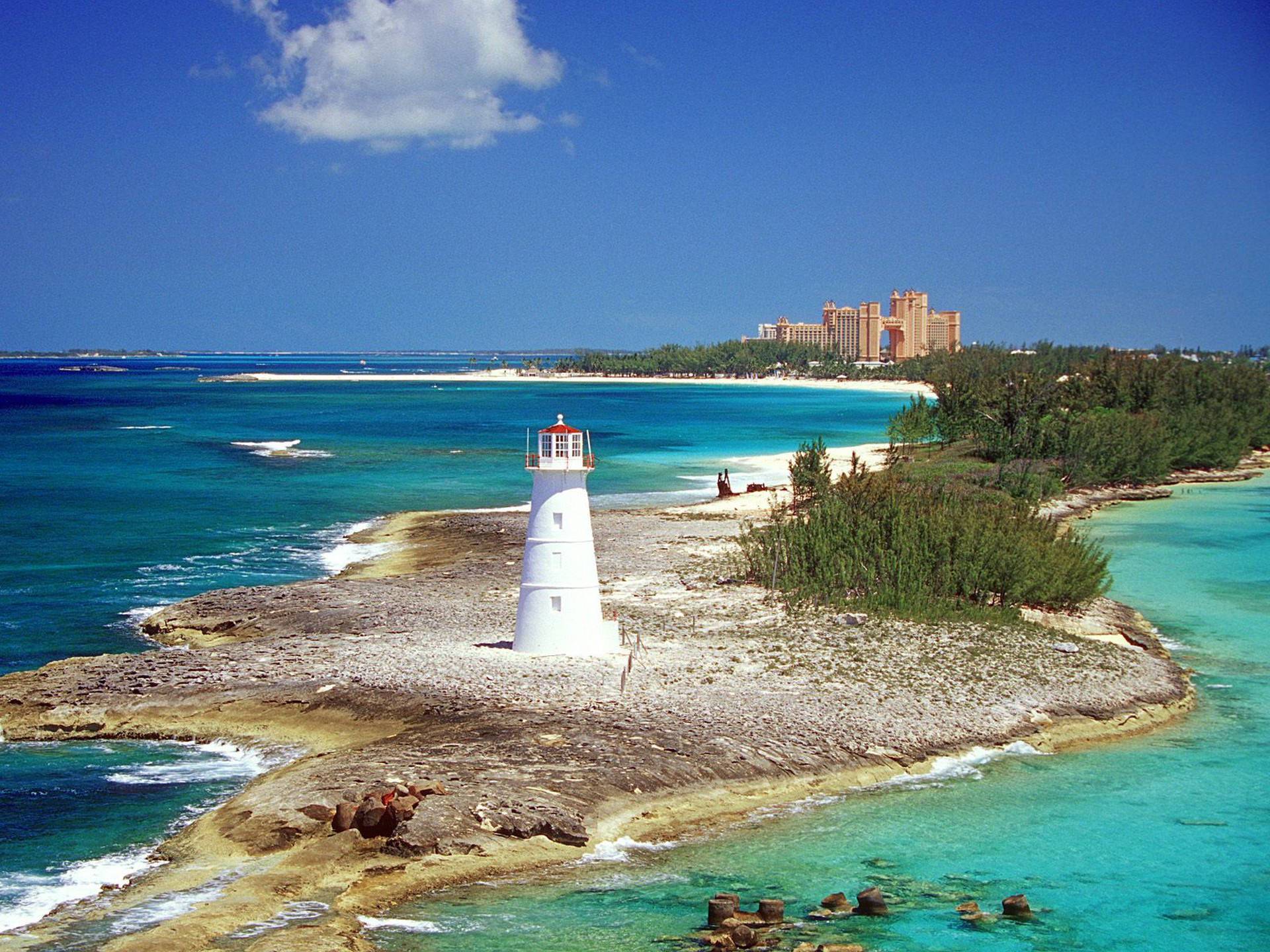 Majestic Lighthouse Overlooking Nassau Beach, Caribbean Background