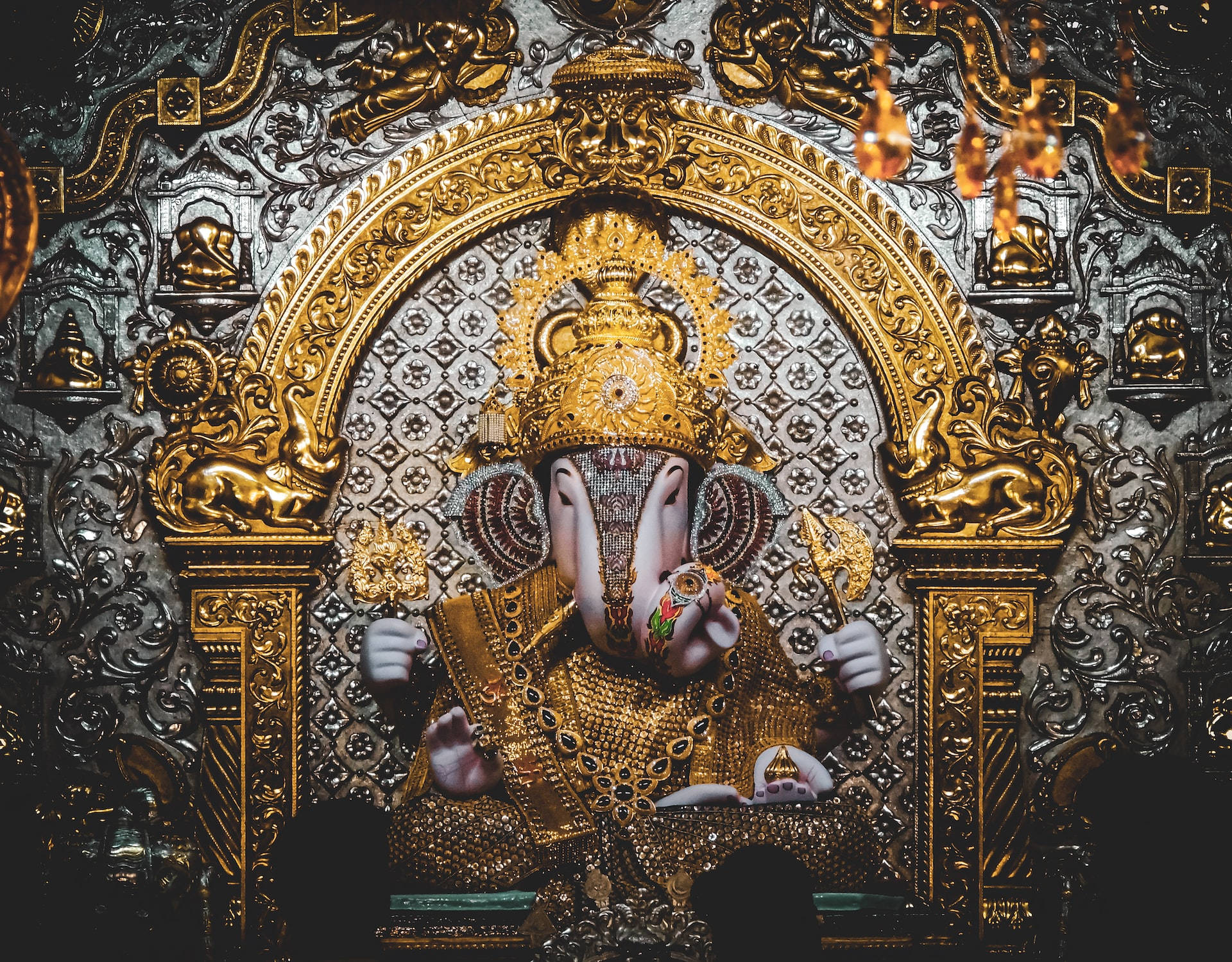 Majestic Lord Ganesh Altar In Silver And Gold Background