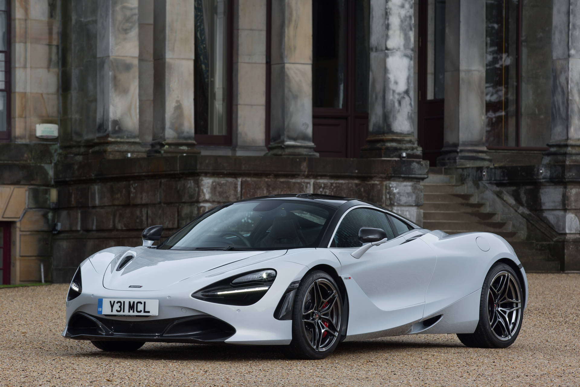 Majestic Mclaren 720s Parked Against Stone Building Background