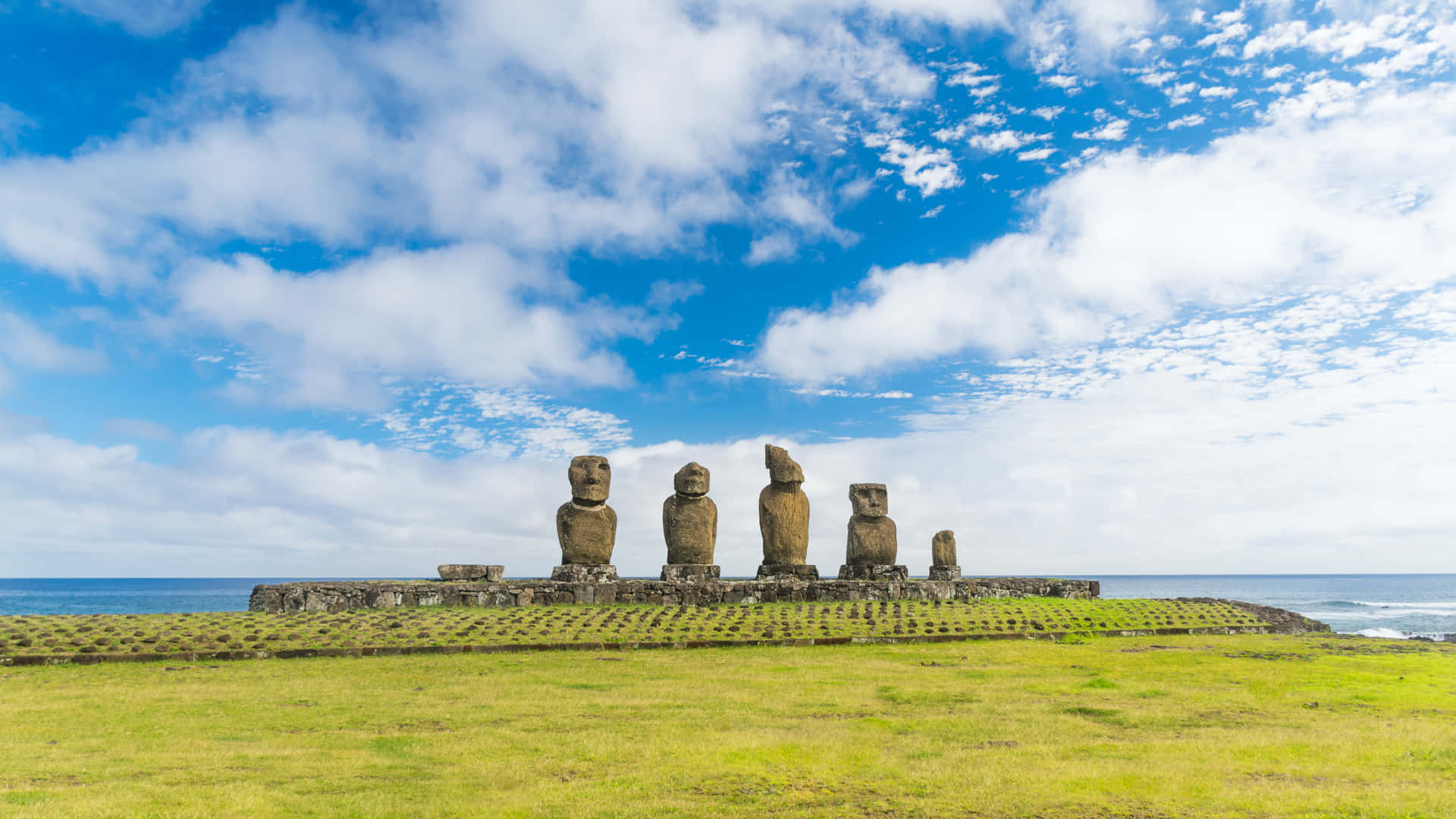 Majestic Moai Statues Bathed In Sunlight Background