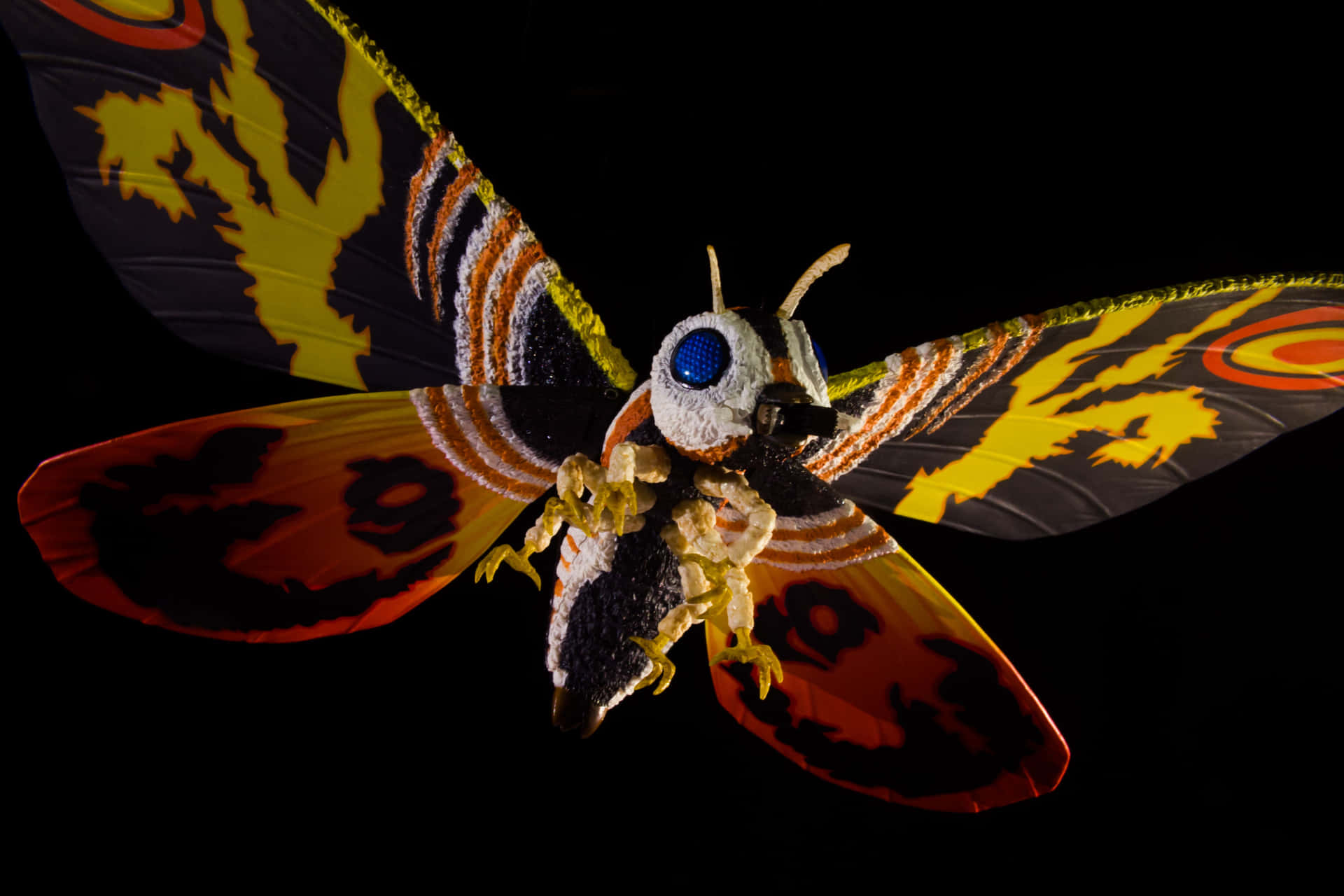 Majestic Mothra Soaring Through The Night Sky Background