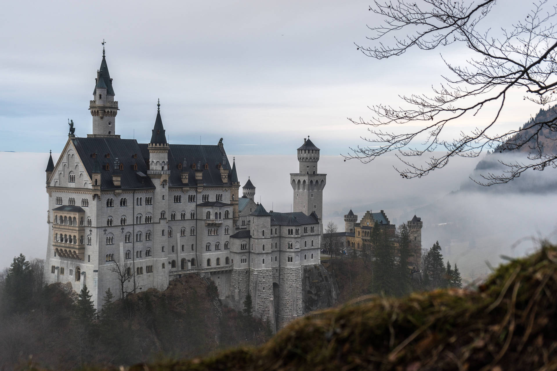 Majestic Neuschwanstein Castle Shrouded In Fog Background