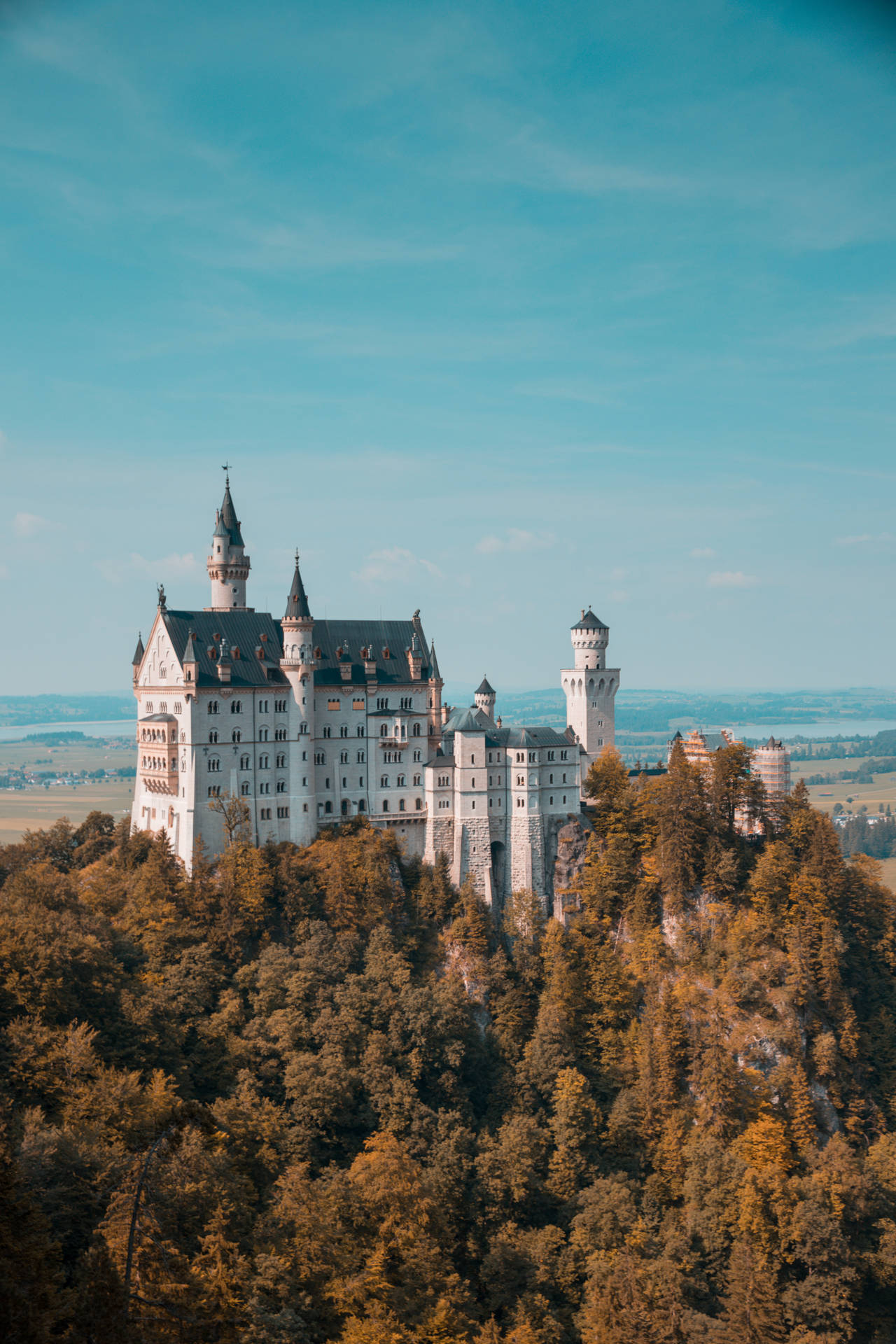 Majestic Neuschwanstein Castle Under Clear Skies Background