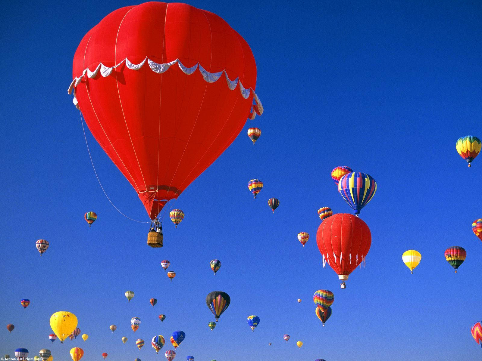 Majestic Red Hot Air Balloons Soaring Over Albuquerque Background