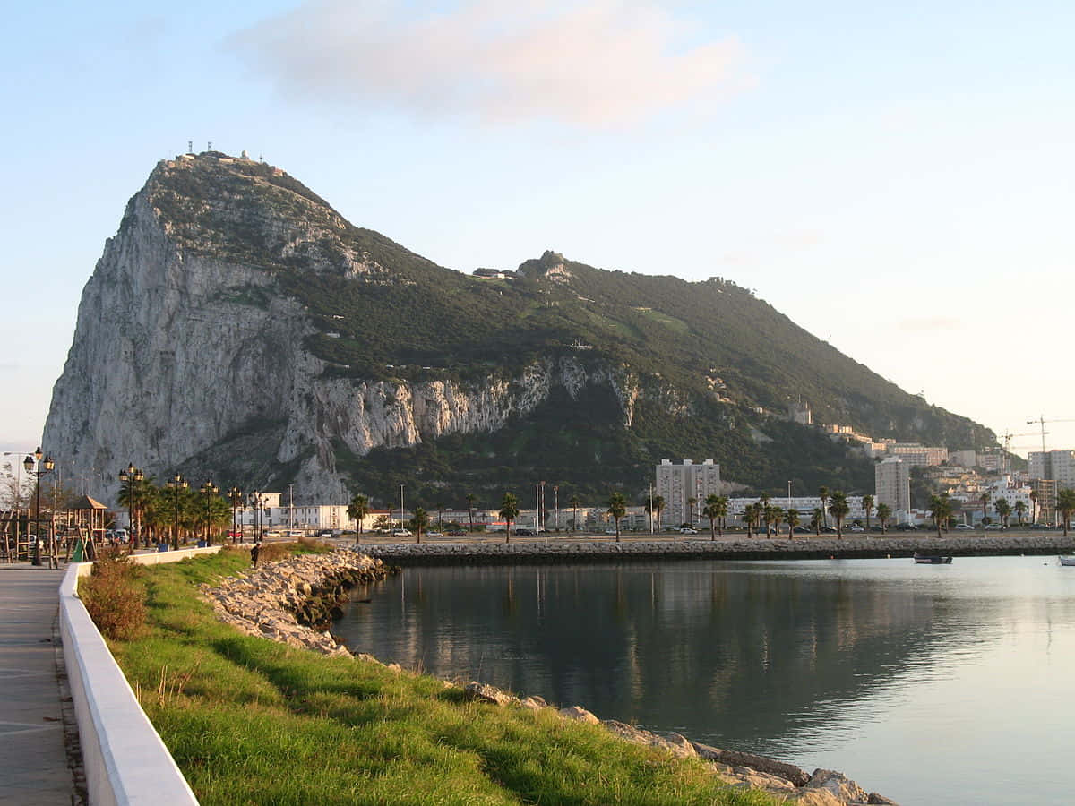Majestic Rock Of Gibraltar Overlooking The Sea Background