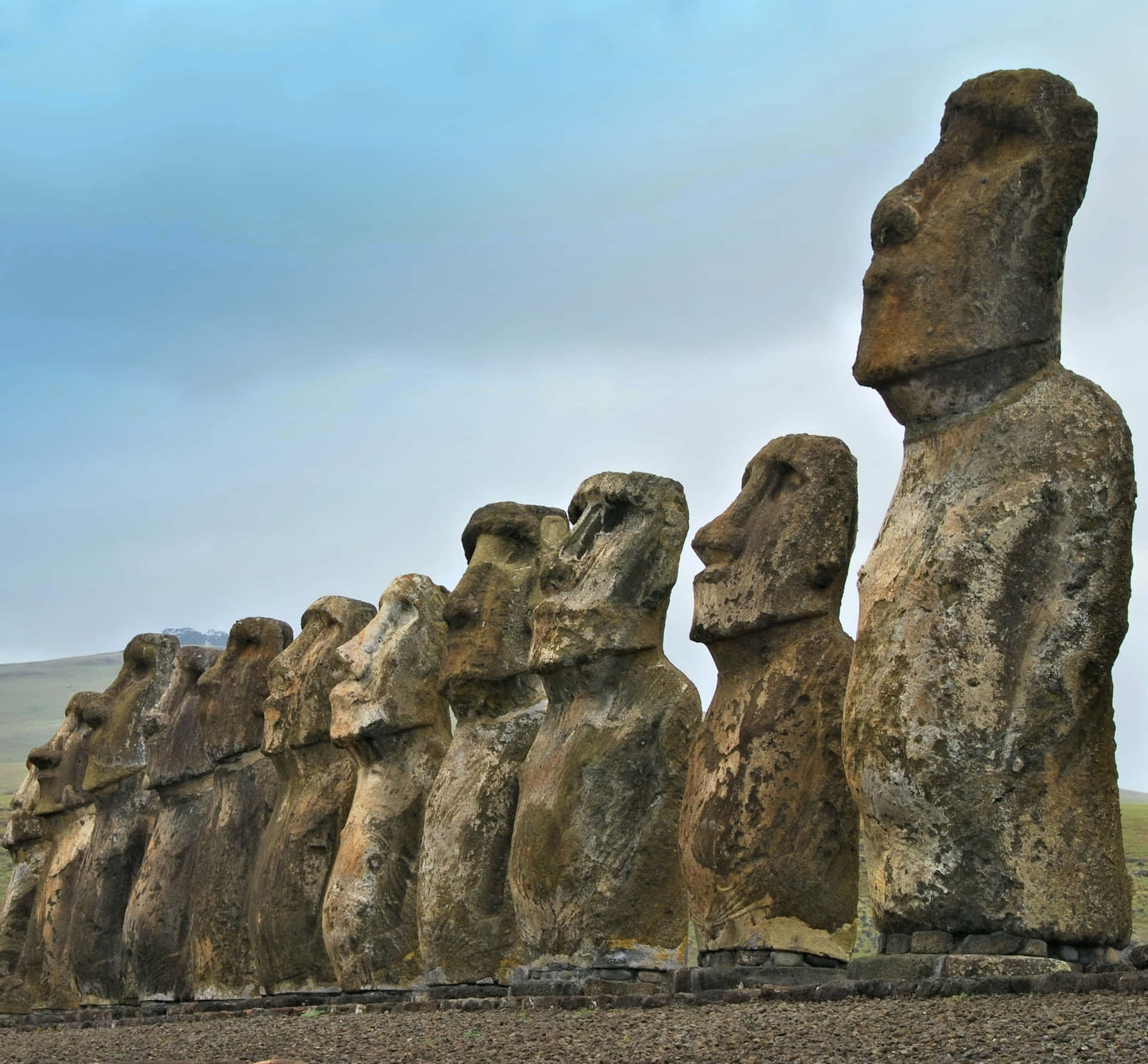 Majestic Row Of Moai Statues On Stone Platform Background