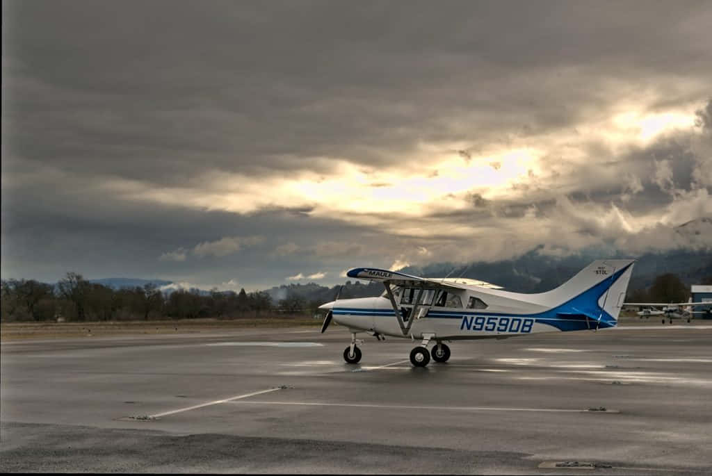 Majestic Small Airplane Resting On Airport Ground