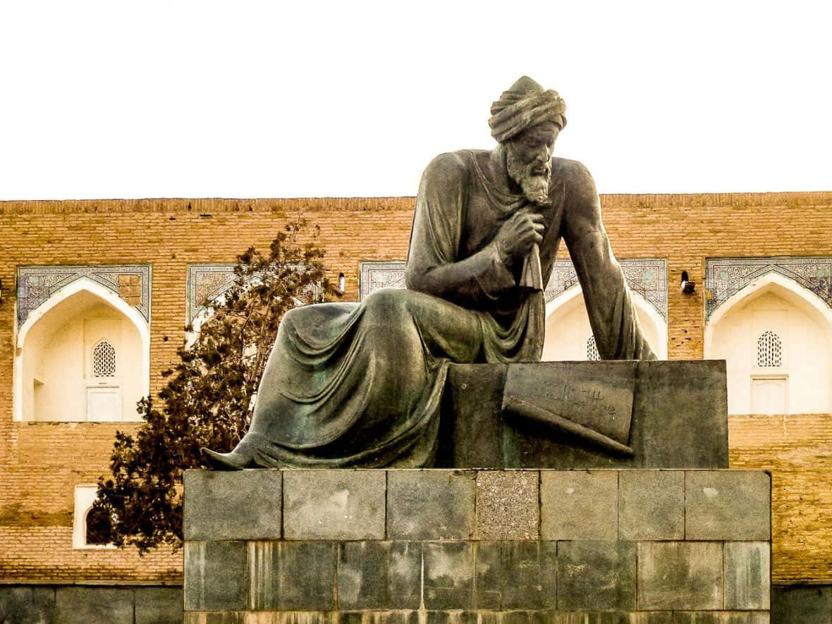 Majestic Statue Overlooking Ancient City Of Khiva Background