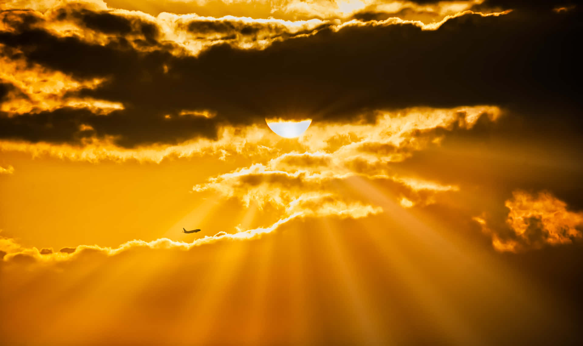 Majestic Sun Rays Illuminating A Golden Sky Background