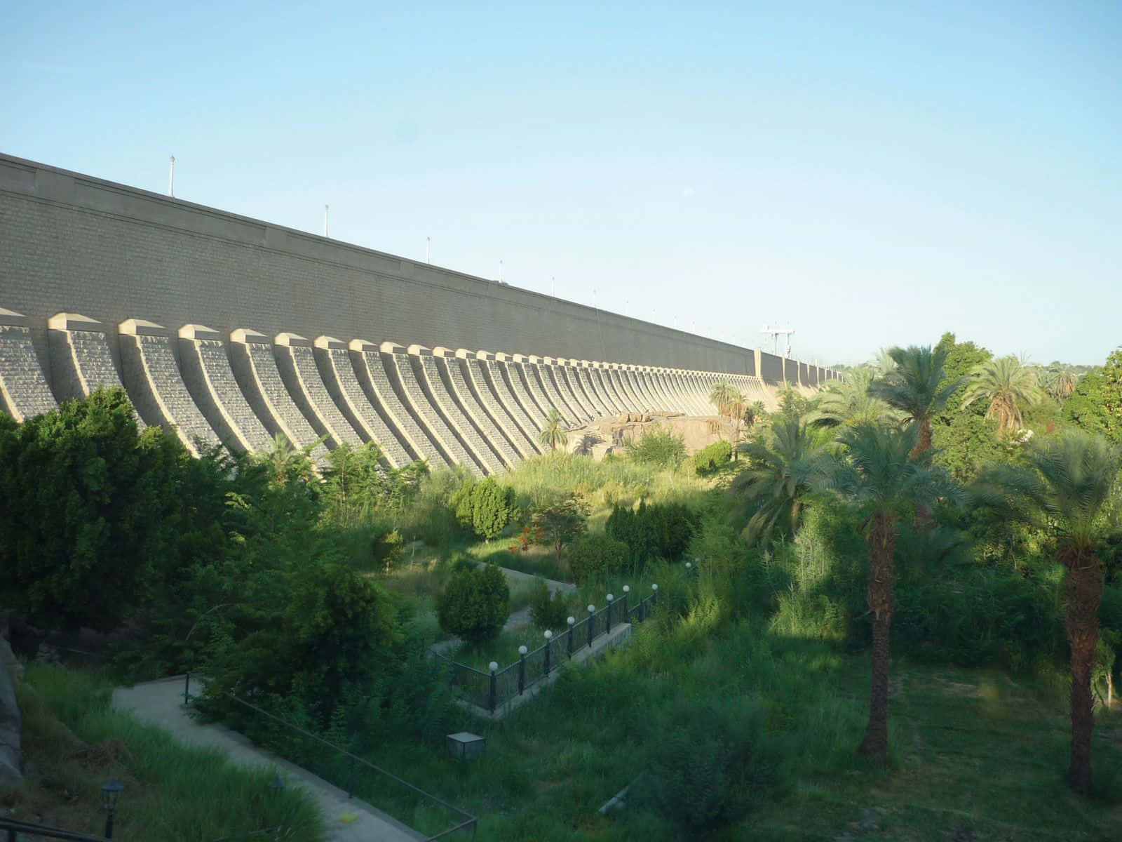 Majestic View Of Aswan High Dam With Green Garden Background
