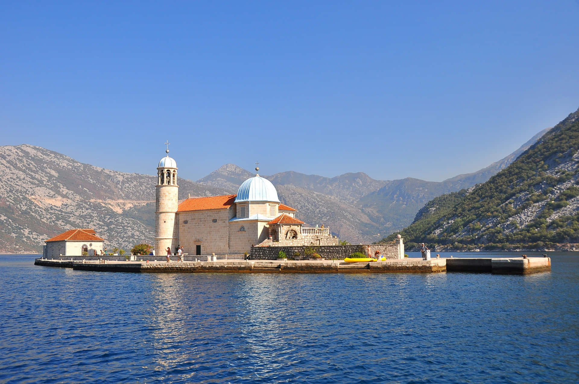Majestic View Of Our Lady Of The Rocks In Montenegro Background