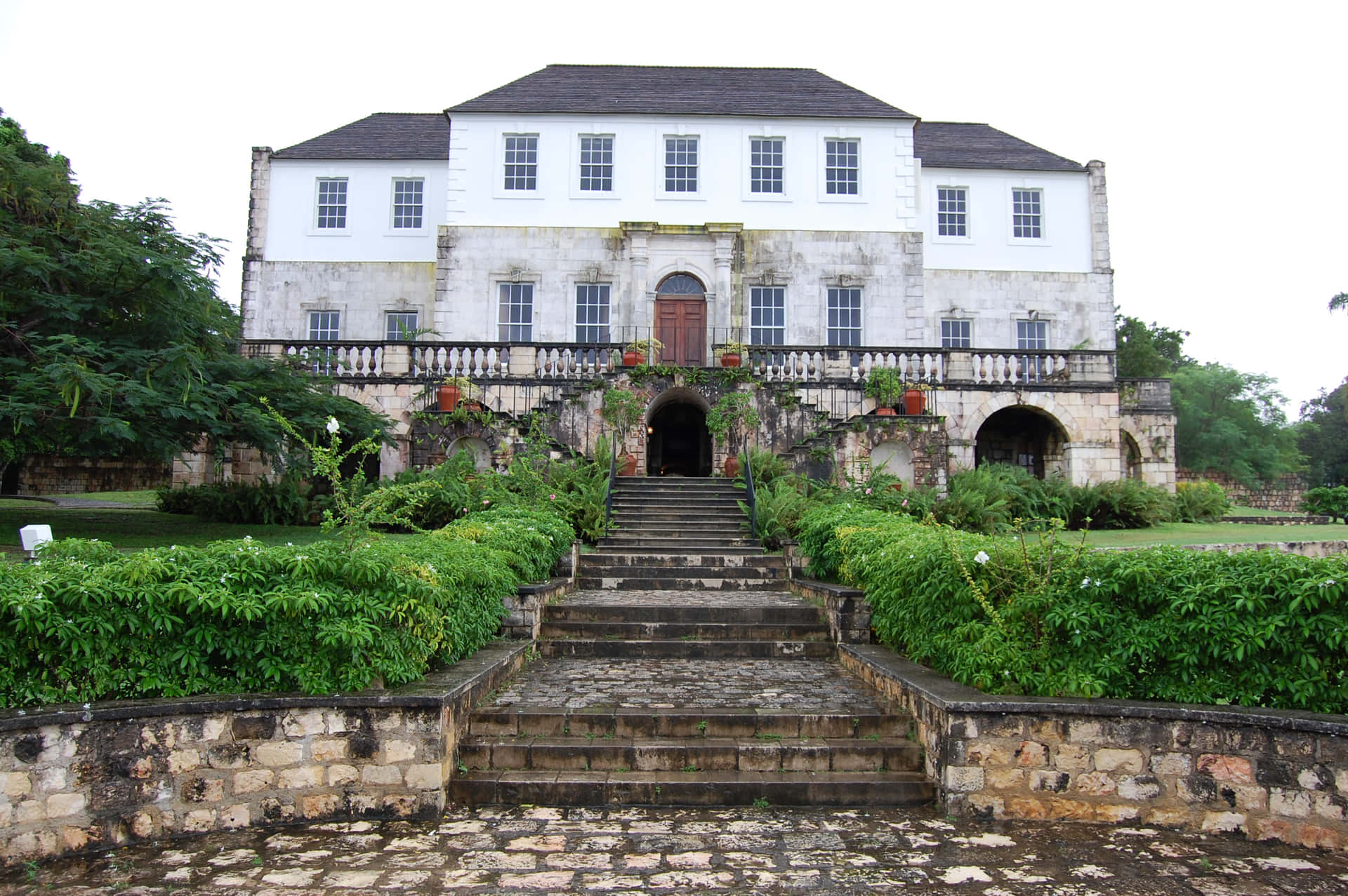 Majestic View Of Rose Hall Great House Under The Clear White Sky Background