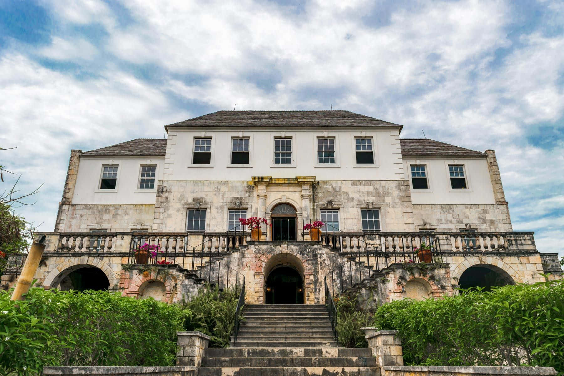 Majestic View Of Rose Hall Great House With A Partially Cloudy Sky Background