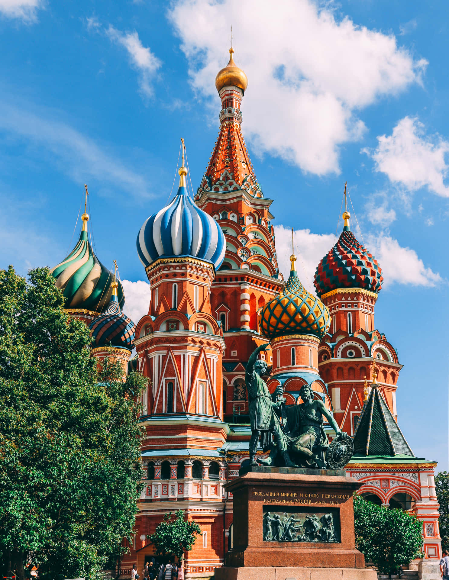 Majestic View Of Saint Basil's Cathedral Amidst Lush Greenery Background