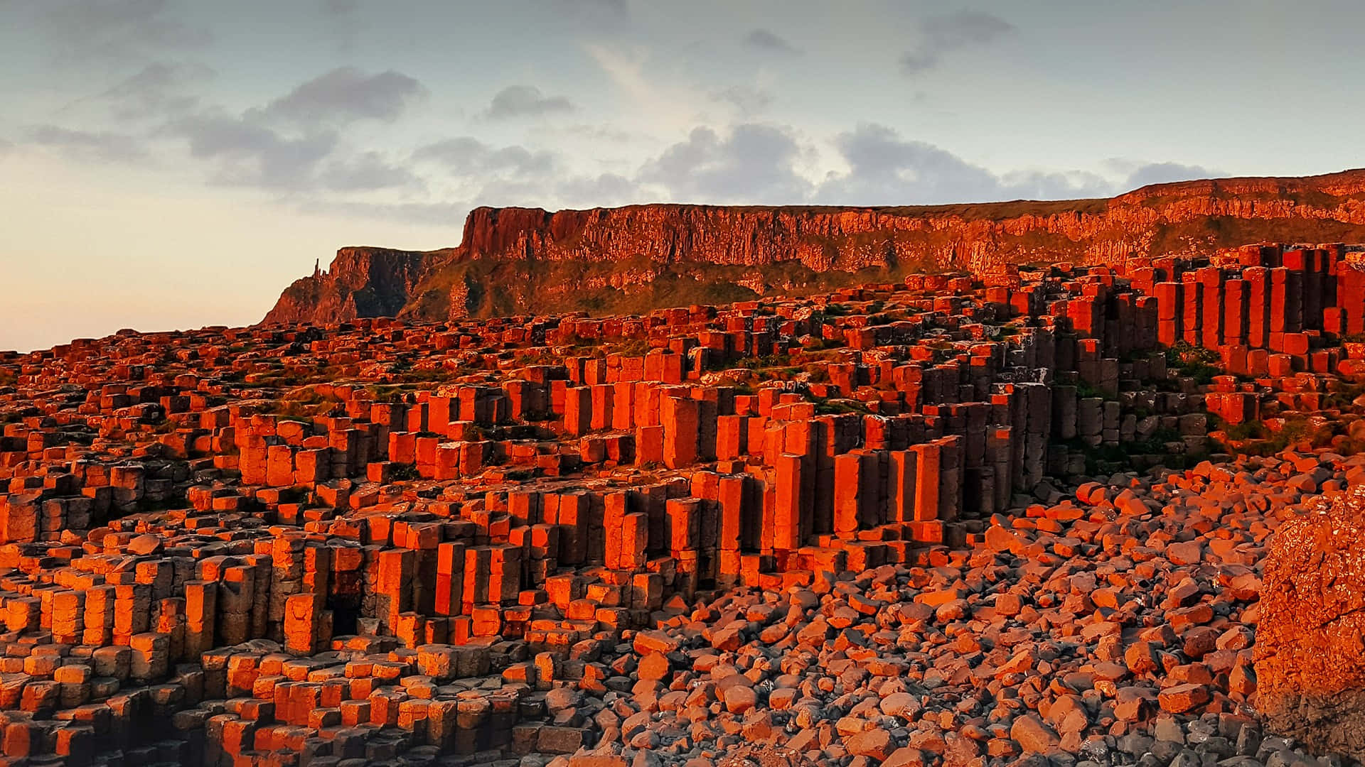 Majestic View Of The Giant's Causeway With Reddish Rocks Under The Blue Sky. Background