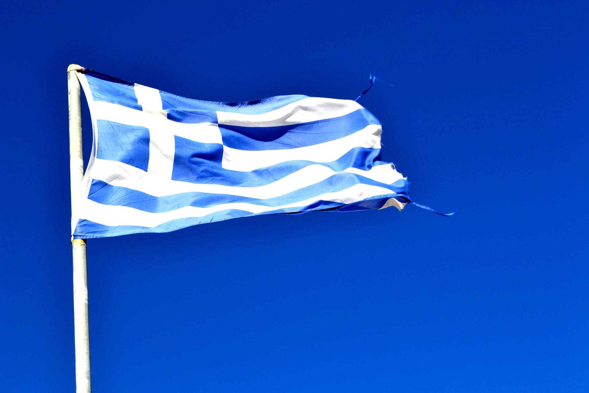 Majestic View Of The Greek Flag Against A Blue Sky Background