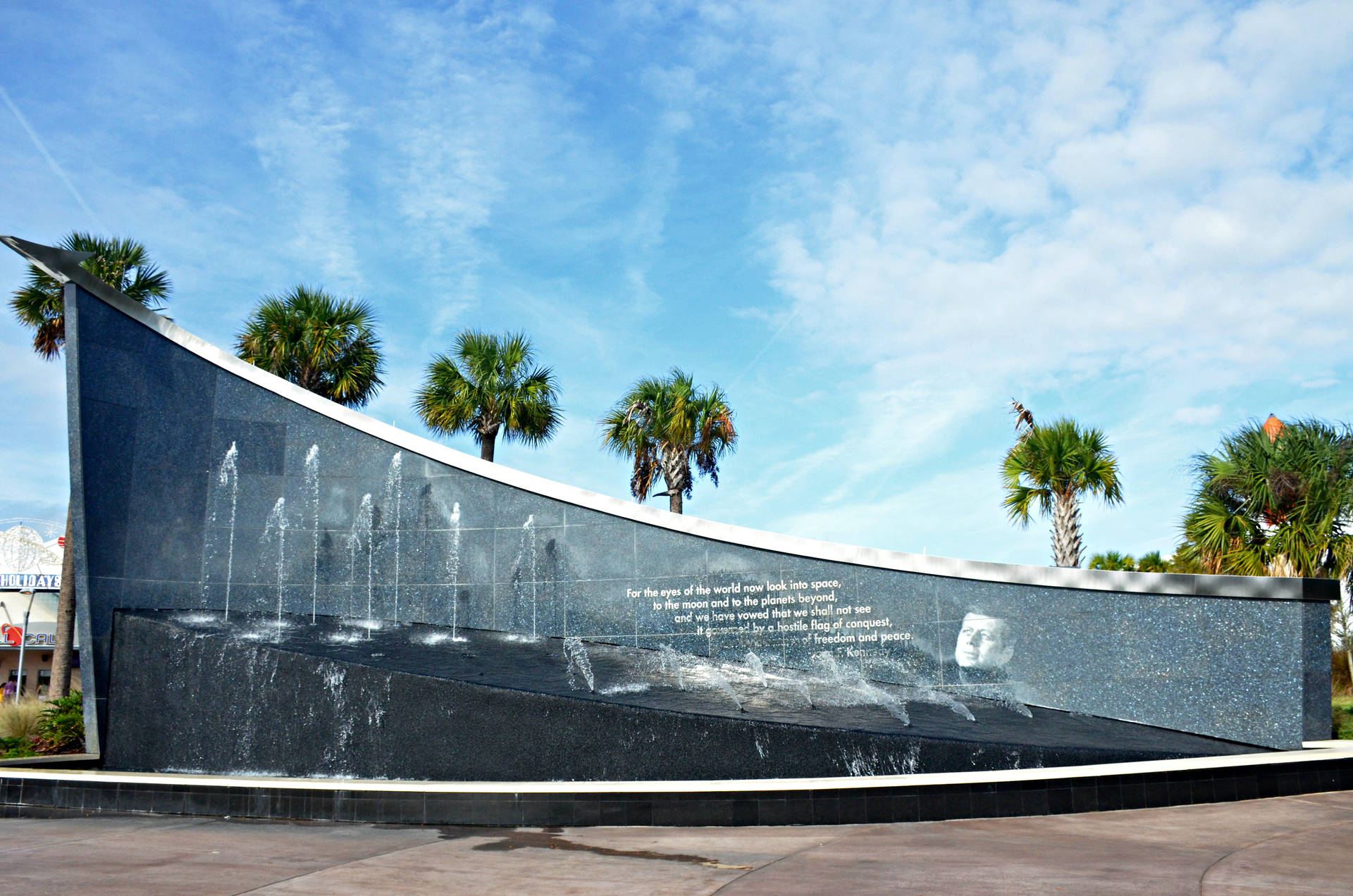 Majestic View Of The Kennedy Space Center With A Sparkling Fountain Background