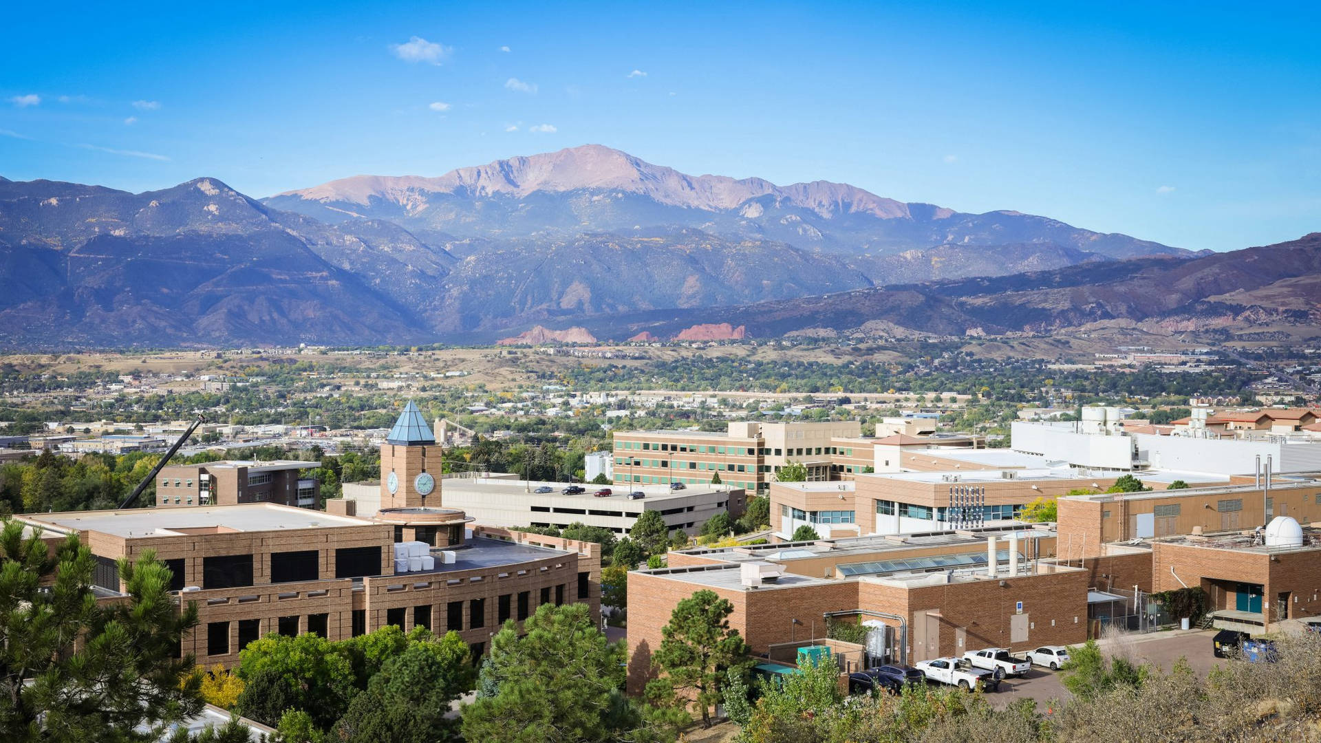 Majestic View Of The University Of Colorado With Mountain Backdrop Background