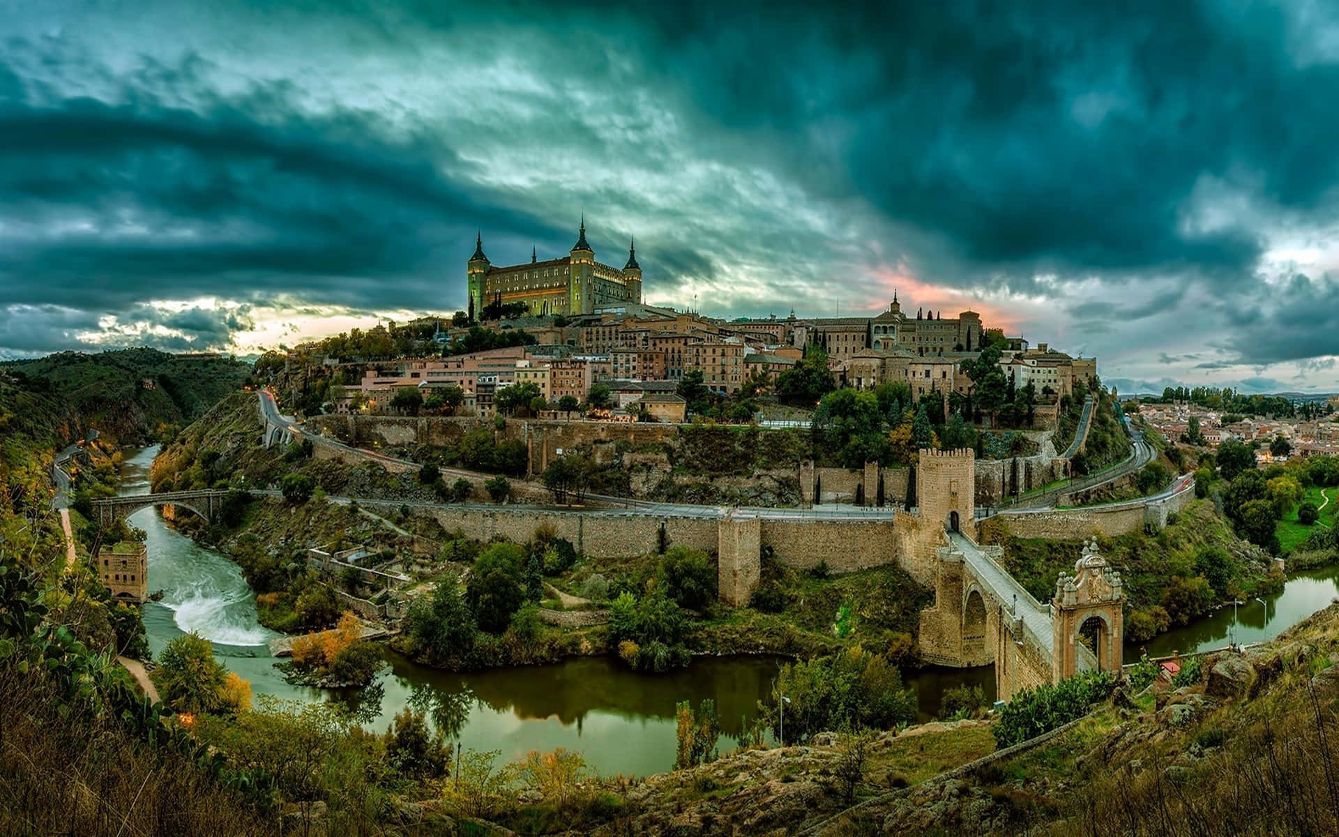 Majestic View Of Toledo Cathedral Under A Vibrant Blue Sky.